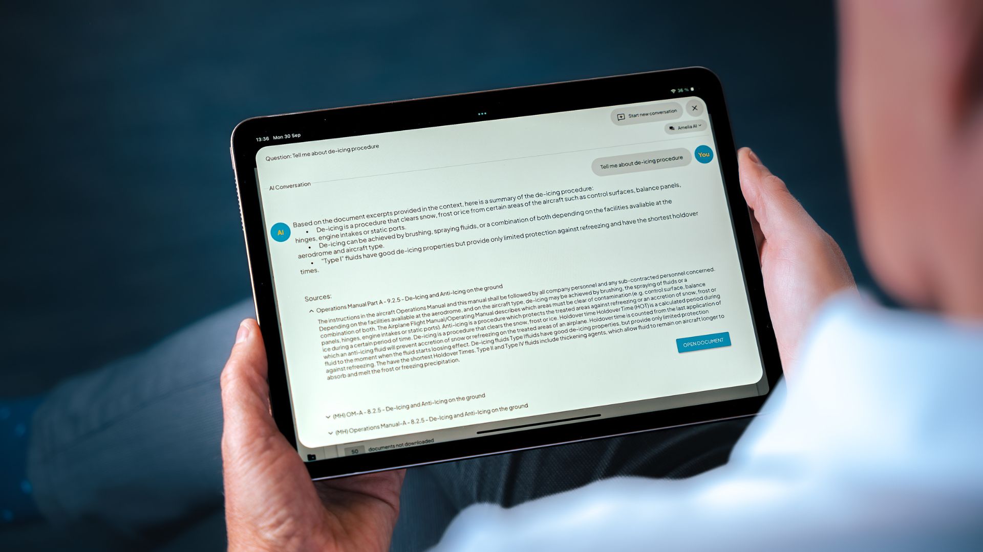 A man holding an Ipad showcasing Amelia AI